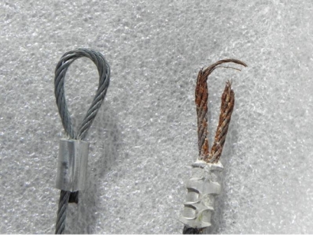 A new steel cable beside a rusted, frayed one