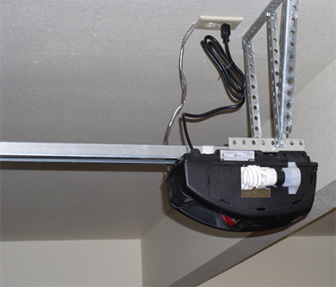 A garage door opener mounted under the ceiling