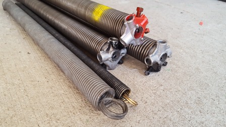 Torsion springs laid out on a concrete floor